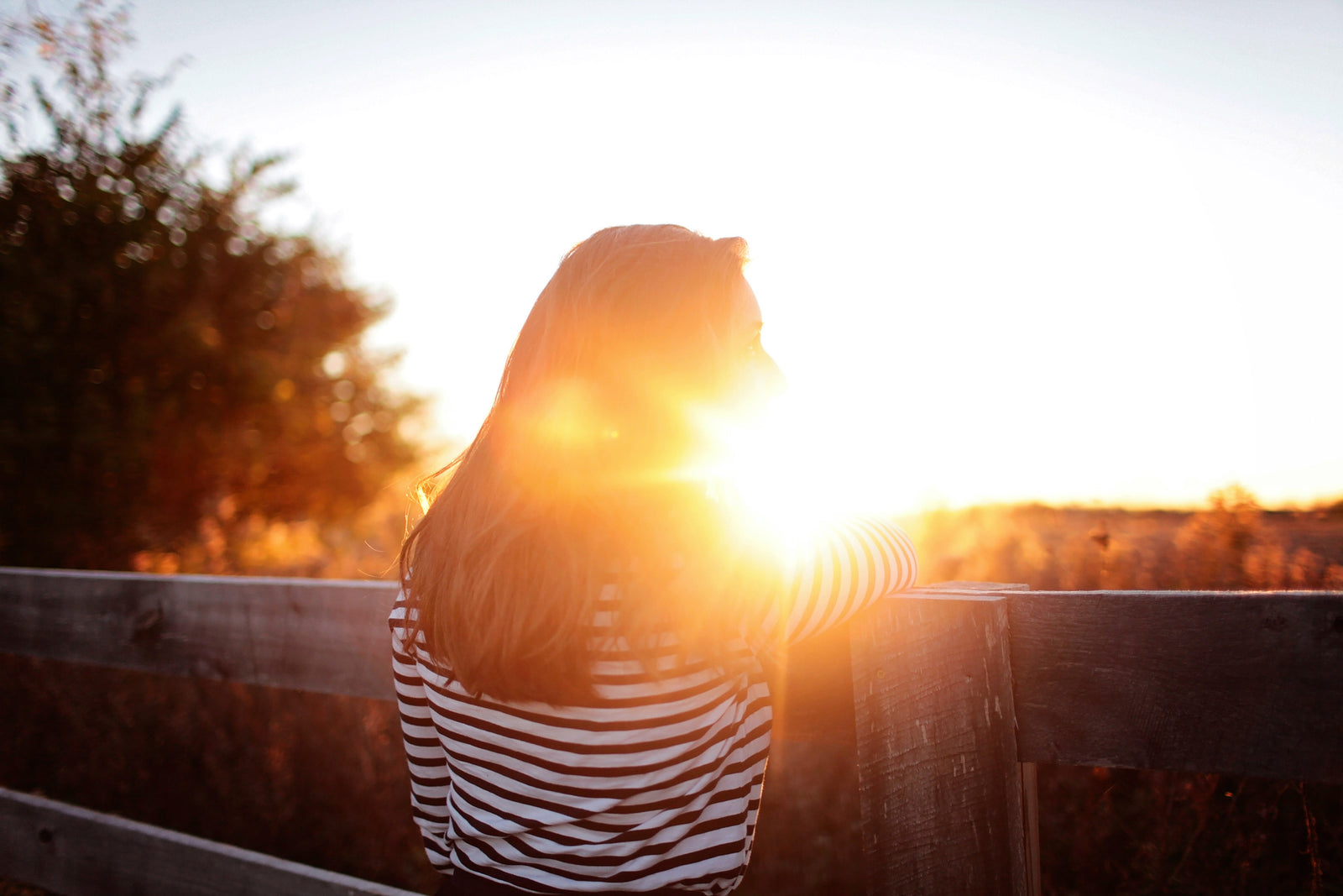 girl enjoying the warm glow of a sunset 