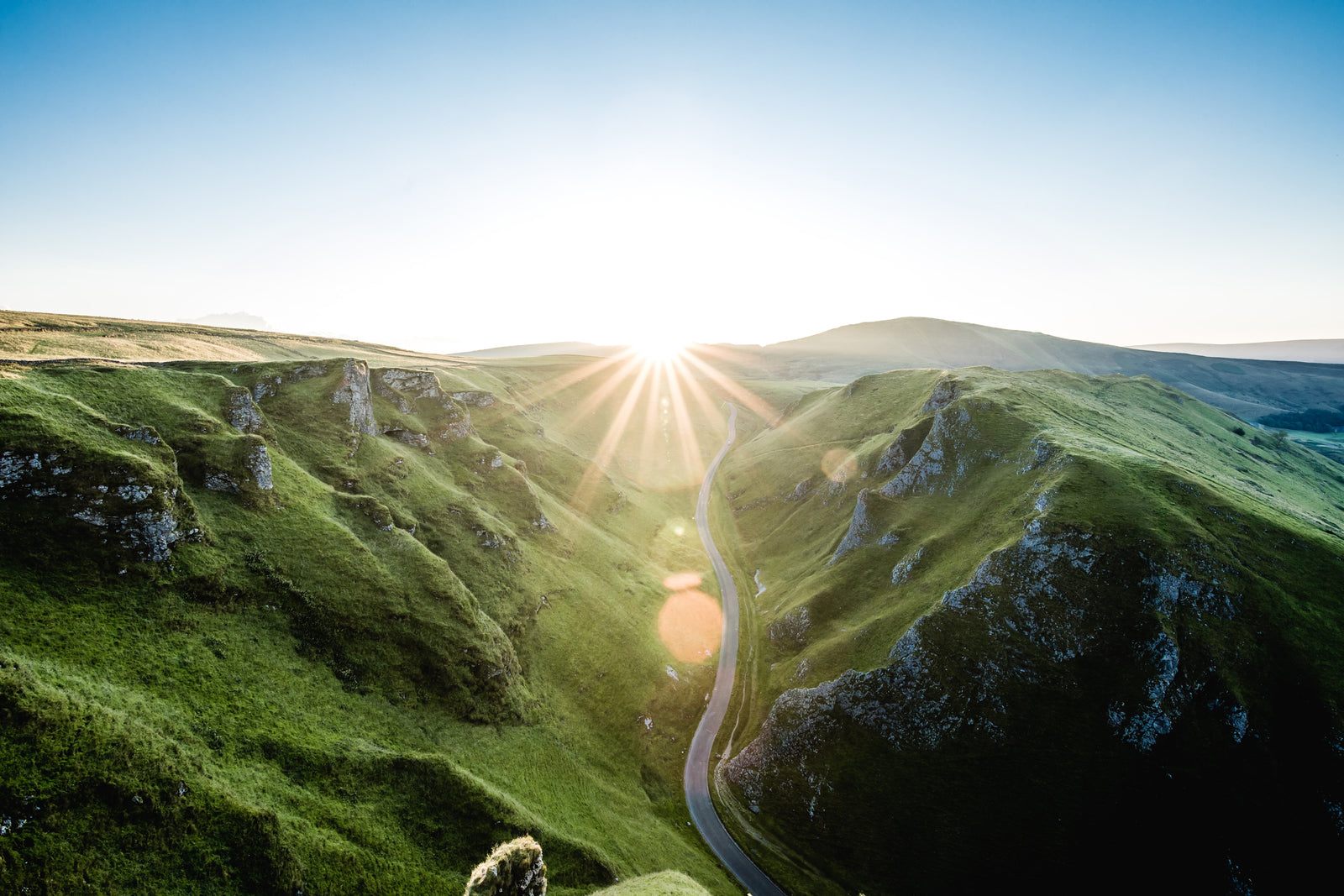 Mountains covered in grass with sunrise