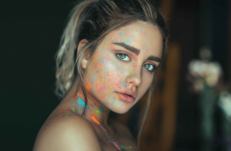 Girl with florescent paint on her face and body