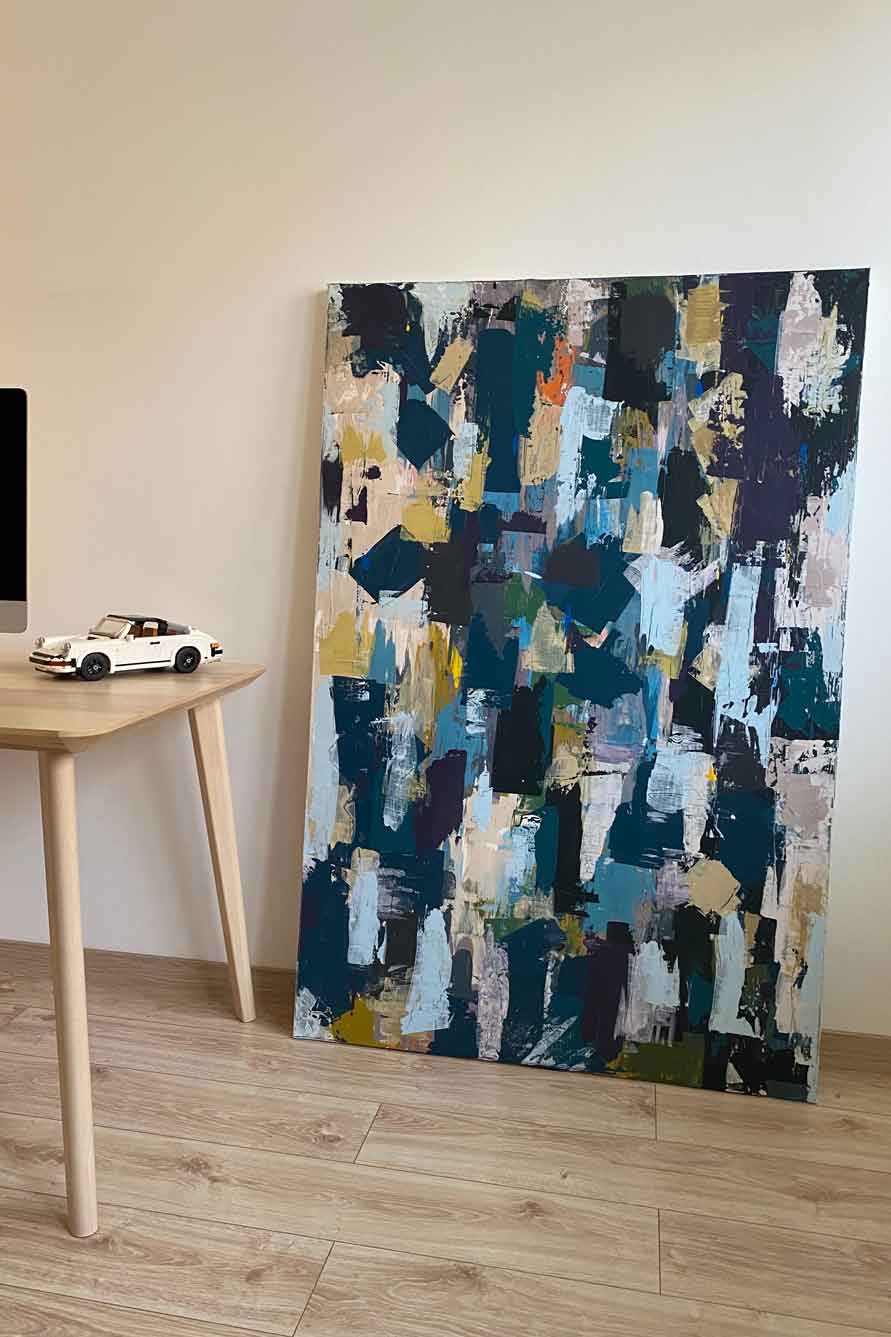 Painting on floor with toy Porsche on table